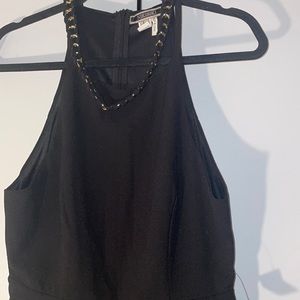 NIKIBIKI (NWT) black jumpsuit with gold and black chain attachment. Size L.